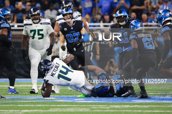 DETROIT,MICHIGAN-September 30: Seattle Seahawks wide receiver DK Metcalf (14) is tackled by Detroit Lions linebacker Malcolm Rodriguez (44)...