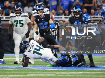 DETROIT,MICHIGAN-September 30: Seattle Seahawks wide receiver DK Metcalf (14) is tackled by Detroit Lions linebacker Malcolm Rodriguez (44)...