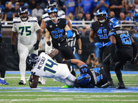 DETROIT,MICHIGAN-September 30: Seattle Seahawks wide receiver DK Metcalf (14) is tackled by Detroit Lions linebacker Malcolm Rodriguez (44)...