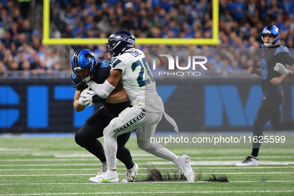 DETROIT,MICHIGAN-September 30: Detroit Lions offensive tackle Taylor Decker (68) is tackled by Seattle Seahawks safety Julian Love (20) duri...