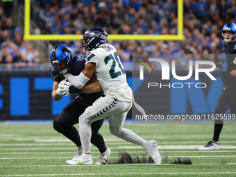 DETROIT,MICHIGAN-September 30: Detroit Lions offensive tackle Taylor Decker (68) is tackled by Seattle Seahawks safety Julian Love (20) duri...