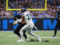 DETROIT,MICHIGAN-September 30: Detroit Lions offensive tackle Taylor Decker (68) is tackled by Seattle Seahawks safety Julian Love (20) duri...