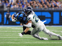 DETROIT,MICHIGAN-September 30: Detroit Lions offensive tackle Taylor Decker (68) is tackled by Seattle Seahawks safety Julian Love (20) duri...