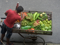 A vegetable seller arranges his van loaded with vegetables as he ferries it for sale to houses in Siliguri, India, on October 1, 2024. (