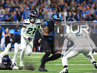 DETROIT,MICHIGAN-September 30: Detroit Lions running back Jahmyr Gibbs (26) runs the ball during the first half of an NFL football game betw...