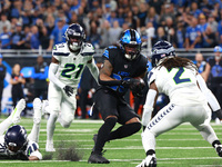 DETROIT,MICHIGAN-September 30: Detroit Lions running back Jahmyr Gibbs (26) runs the ball during the first half of an NFL football game betw...