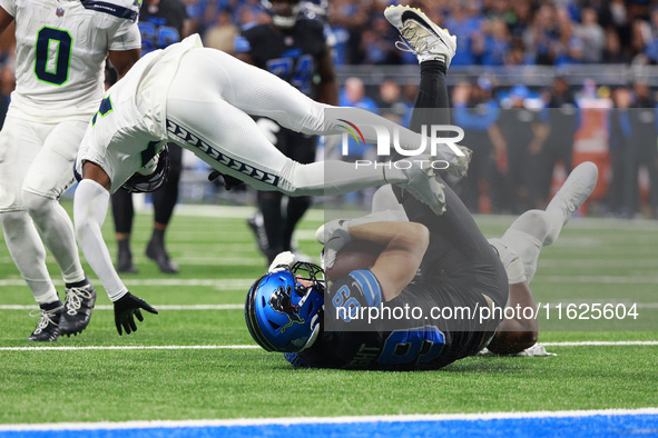 DETROIT,MICHIGAN-September 30: Detroit Lions offensive tackle Taylor Decker (68) is tackled by Seattle Seahawks linebacker Tyus Bowser (56 )...