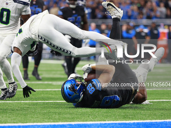 DETROIT,MICHIGAN-September 30: Detroit Lions offensive tackle Taylor Decker (68) is tackled by Seattle Seahawks linebacker Tyus Bowser (56 )...