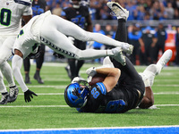 DETROIT,MICHIGAN-September 30: Detroit Lions offensive tackle Taylor Decker (68) is tackled by Seattle Seahawks linebacker Tyus Bowser (56 )...