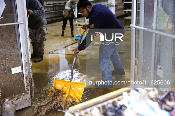 Volunteers clean up storm damage at CJ's Market in Lansing, North Carolina on September 30, 2024 after Hurricane Helene caused widespread da...