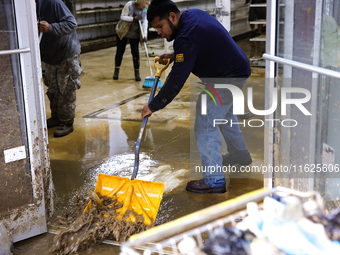 Volunteers clean up storm damage at CJ's Market in Lansing, North Carolina on September 30, 2024 after Hurricane Helene caused widespread da...