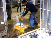 Volunteers clean up storm damage at CJ's Market in Lansing, North Carolina on September 30, 2024 after Hurricane Helene caused widespread da...