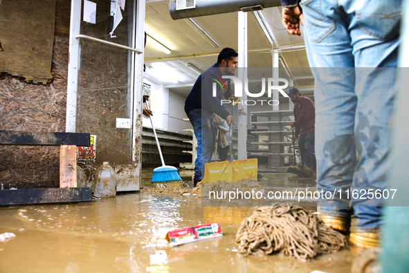 Volunteers clean up storm damage at CJ's Market in Lansing, North Carolina on September 30, 2024 after Hurricane Helene caused widespread da...