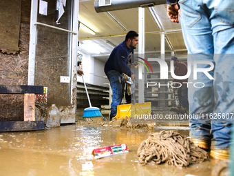 Volunteers clean up storm damage at CJ's Market in Lansing, North Carolina on September 30, 2024 after Hurricane Helene caused widespread da...