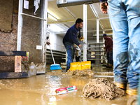 Volunteers clean up storm damage at CJ's Market in Lansing, North Carolina on September 30, 2024 after Hurricane Helene caused widespread da...