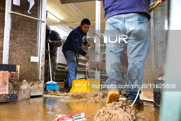 Volunteers clean up storm damage at CJ's Market in Lansing, North Carolina on September 30, 2024 after Hurricane Helene caused widespread da...