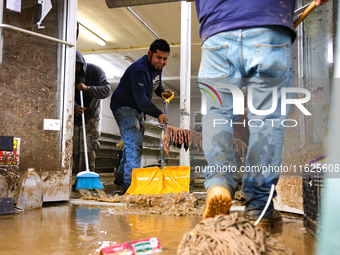 Volunteers clean up storm damage at CJ's Market in Lansing, North Carolina on September 30, 2024 after Hurricane Helene caused widespread da...