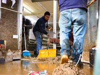 Volunteers clean up storm damage at CJ's Market in Lansing, North Carolina on September 30, 2024 after Hurricane Helene caused widespread da...