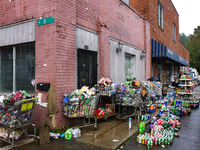 Shopping carts hold damaged products outside of CJ's Market in Lansing, North Carolina on September 30, 2024 after Hurricane Helene destroye...