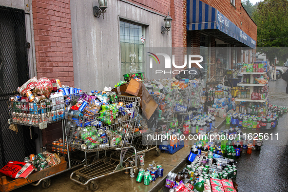 Shopping carts hold damaged products outside of CJ's Market in Lansing, North Carolina on September 30, 2024 after Hurricane Helene destroye...