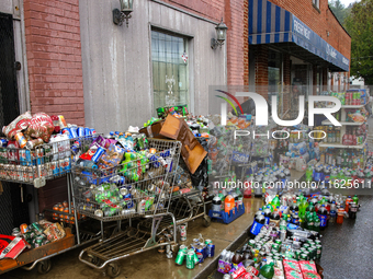 Shopping carts hold damaged products outside of CJ's Market in Lansing, North Carolina on September 30, 2024 after Hurricane Helene destroye...