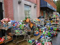 Shopping carts hold damaged products outside of CJ's Market in Lansing, North Carolina on September 30, 2024 after Hurricane Helene destroye...