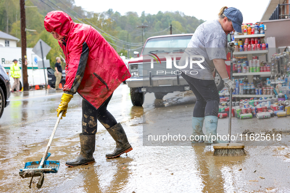 Tricia Hart, co-owner of CJ's Market in Lansing, North Carolina, cleans up storm damage on September 30, 2024 after Hurricane Helene caused...