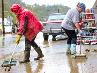 Tricia Hart, co-owner of CJ's Market in Lansing, North Carolina, cleans up storm damage on September 30, 2024 after Hurricane Helene caused...