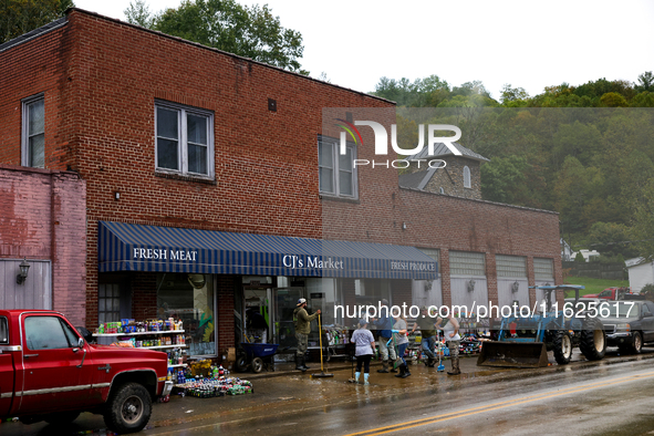 Volunteers clean up storm damage at CJ's Market in Lansing, North Carolina on September 30, 2024 after Hurricane Helene caused widespread da...