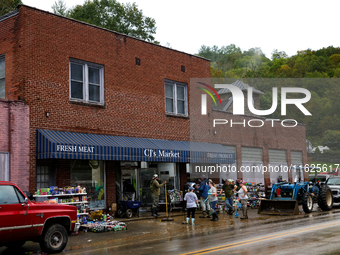 Volunteers clean up storm damage at CJ's Market in Lansing, North Carolina on September 30, 2024 after Hurricane Helene caused widespread da...