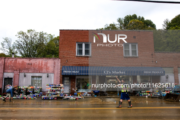 A volunteer helps clean up storm damage at CJ's Market in Lansing, North Carolina on September 30, 2024 after Hurricane Helene caused widesp...