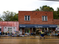 A volunteer helps clean up storm damage at CJ's Market in Lansing, North Carolina on September 30, 2024 after Hurricane Helene caused widesp...