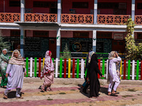 Women walk to cast their votes in the third phase of Assembly elections in Handwara, Jammu and Kashmir, India, on October 1, 2024. (