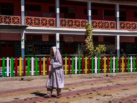 A woman walks after casting her vote in the third phase of Assembly elections in Handwara, Jammu and Kashmir, India, on October 1, 2024. (