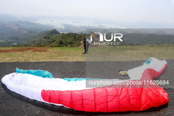 A paragliding athlete prepares to take part in a paragliding competition in Sumedang, Indonesia, on October 1, 2024. The paragliding competi...