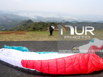 A paragliding athlete prepares to take part in a paragliding competition in Sumedang, Indonesia, on October 1, 2024. The paragliding competi...