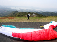 A paragliding athlete prepares to take part in a paragliding competition in Sumedang, Indonesia, on October 1, 2024. The paragliding competi...