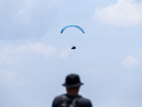 A paragliding athlete takes part in a paragliding competition in Sumedang, Indonesia, on October 1, 2024. Various athletes from countries in...