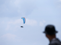 A paragliding athlete takes part in a paragliding competition in Sumedang, Indonesia, on October 1, 2024. Various athletes from countries in...