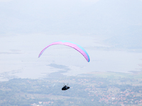 A paragliding athlete takes part in a paragliding competition in Sumedang, Indonesia, on October 1, 2024. Various athletes from countries in...