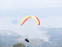 A paragliding athlete takes part in a paragliding competition in Sumedang, Indonesia, on October 1, 2024. Various athletes from countries in...