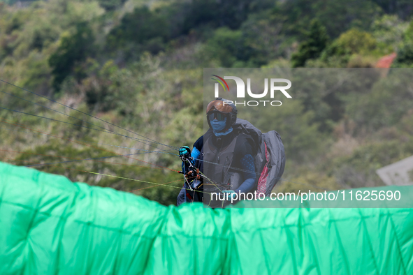 A paragliding athlete prepares to take part in a paragliding competition in Sumedang, Indonesia, on October 1, 2024. The paragliding competi...