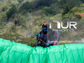 A paragliding athlete prepares to take part in a paragliding competition in Sumedang, Indonesia, on October 1, 2024. The paragliding competi...