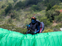 A paragliding athlete prepares to take part in a paragliding competition in Sumedang, Indonesia, on October 1, 2024. The paragliding competi...