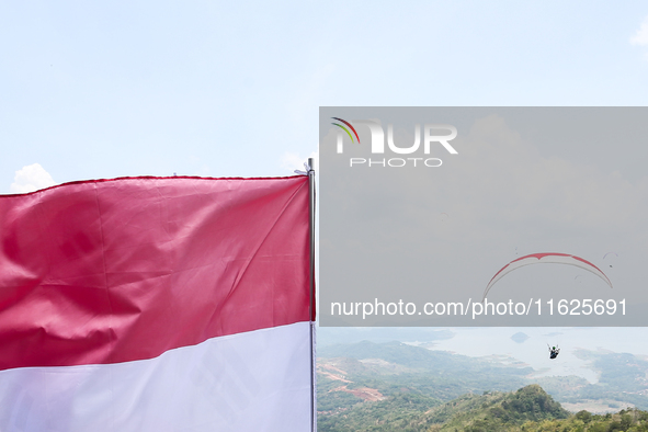 A paragliding athlete takes part in a paragliding competition in Sumedang, Indonesia, on October 1, 2024. Various athletes from countries in...