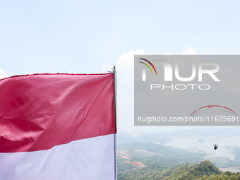 A paragliding athlete takes part in a paragliding competition in Sumedang, Indonesia, on October 1, 2024. Various athletes from countries in...