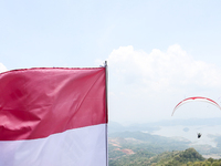 A paragliding athlete takes part in a paragliding competition in Sumedang, Indonesia, on October 1, 2024. Various athletes from countries in...