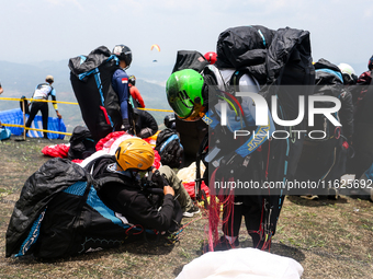 A number of paragliding athletes prepare to take part in a paragliding competition in Sumedang, Indonesia, on October 1, 2024. The paraglidi...