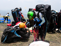 A number of paragliding athletes prepare to take part in a paragliding competition in Sumedang, Indonesia, on October 1, 2024. The paraglidi...