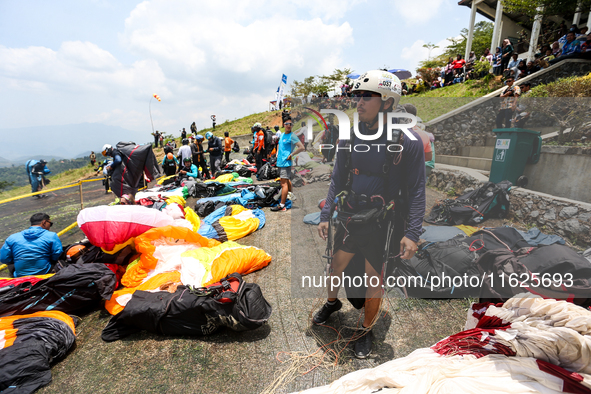 A number of paragliding athletes prepare to take part in a paragliding competition in Sumedang, Indonesia, on October 1, 2024. The paraglidi...